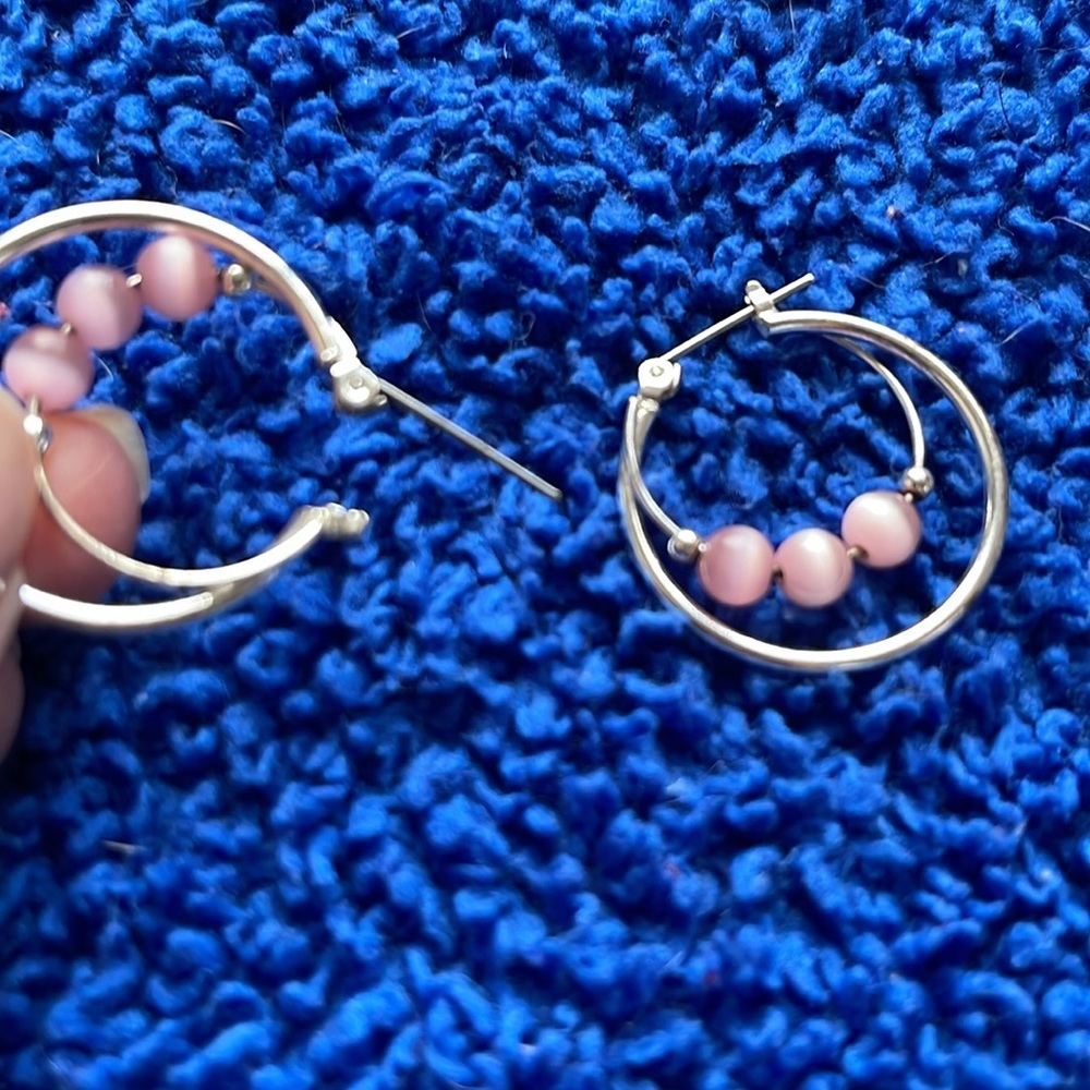 Faux silver double hoop earrings with pink balls.